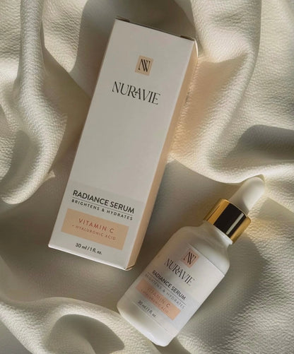 Nuravie Radiance Serum packaging and bottle on a soft fabric background
